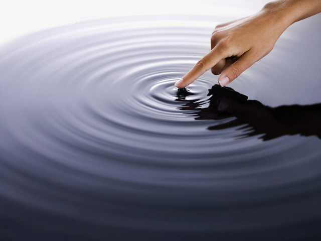 Hand touching water